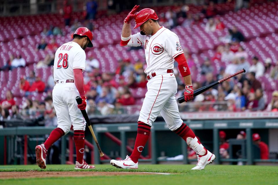 Cincinnati Reds first baseman Joey Votto (19) walks up the batterÕs box after Cincinnati Reds left fielder Tommy Pham (28), background, struck out during the first inning of a baseball game against the San Diego Padres, Wednesday, April 27, 2022, at Great American Ball Park in Cincinnati.