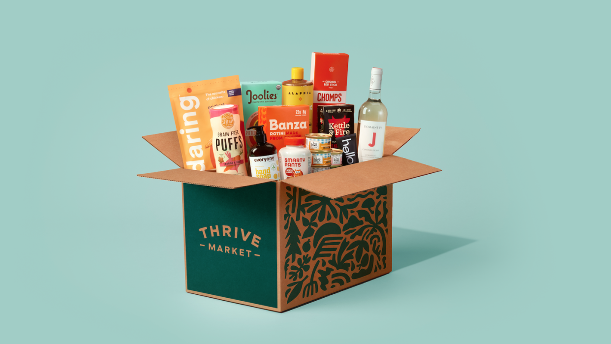 box of thrive market groceries on a pink and green background
