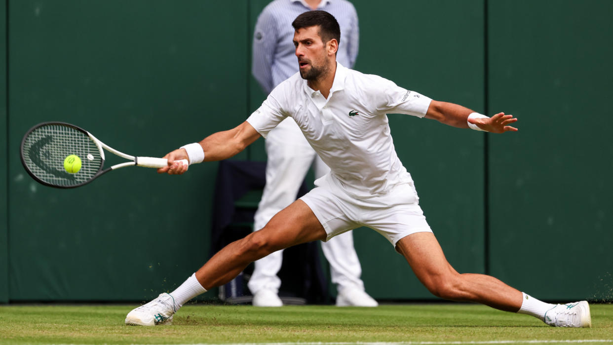  Novak Djokovic at full stretch for a forehand return at the baseline 