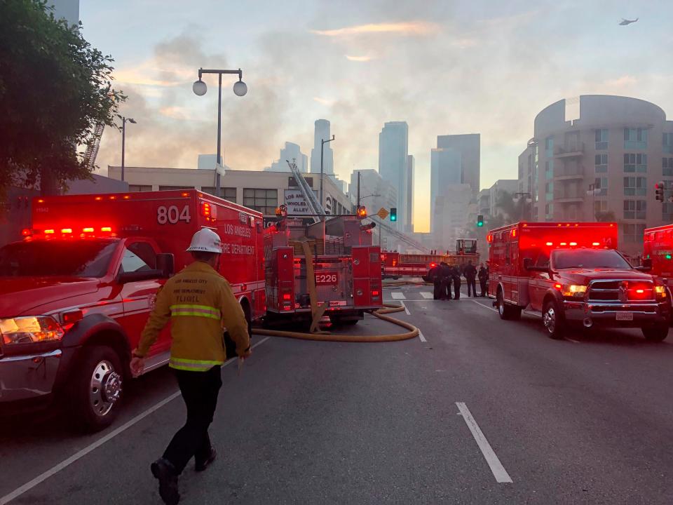 Firefighters respond to an explosion in downtown Los Angeles on Saturday that injured multiple firefighters and caused a fire that spread to several buildings, authorities say.