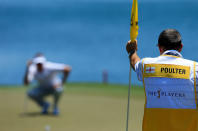 PONTE VEDRA BEACH, FL - MAY 10: Caddie Terry Mundy (R) holds the flag as Ian Poulter (L) of England lines up his putt on the 18th hole during the first round of THE PLAYERS Championship held at THE PLAYERS Stadium course at TPC Sawgrass on May 10, 2012 in Ponte Vedra Beach, Florida. (Photo by David Cannon/Getty Images)