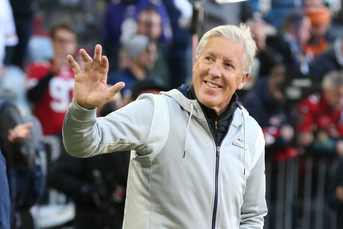 Seattle Seahawks head coach Pete Carroll waves to fans as he walks onto the field before an NFL football game against the Tampa Bay Buccaneers, Sunday, Nov. 13, 2022, in Munich, Germany. (AP Photo/Gary McCullough)