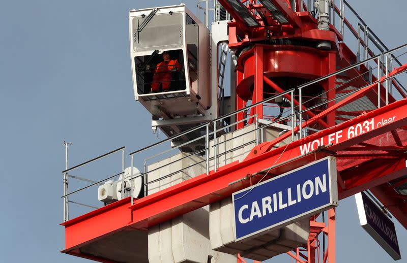 FILE PHOTO: A worker operates a crane on Carillion's Midland Metropolitan Hospital construction site in Smethwick