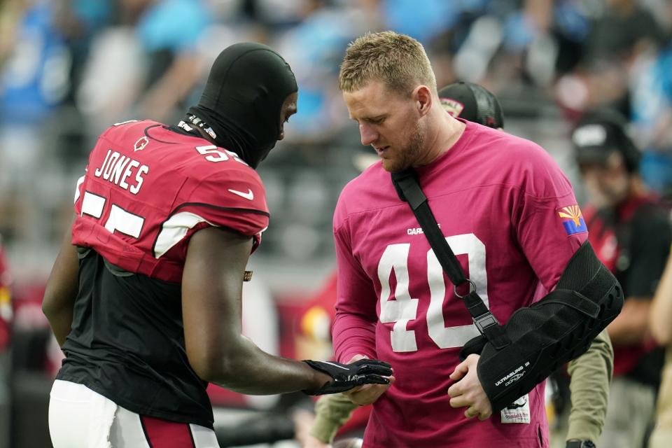 Arizona Cardinals outside linebacker Chandler Jones, left, talks with injured Cardinals' J.J. Watt prior to an NFL football game against the Carolina Panthers Sunday, Nov. 14, 2021, in Glendale, Ariz. (AP Photo/Darryl Webb)