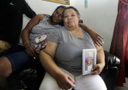 <p>Stephanie White, right, holds a photograph of her son Stef'an Strawder during an interview in her home in Lehigh Acres, Fla., Monday, July 25, 2016. Strawder, 18, was killed in the deadly shooting outside the Club Blu nightclub in Fort Myers, Fla., Monday. At left is Kasey Jones. (AP Photo/Lynne Sladky)</p>