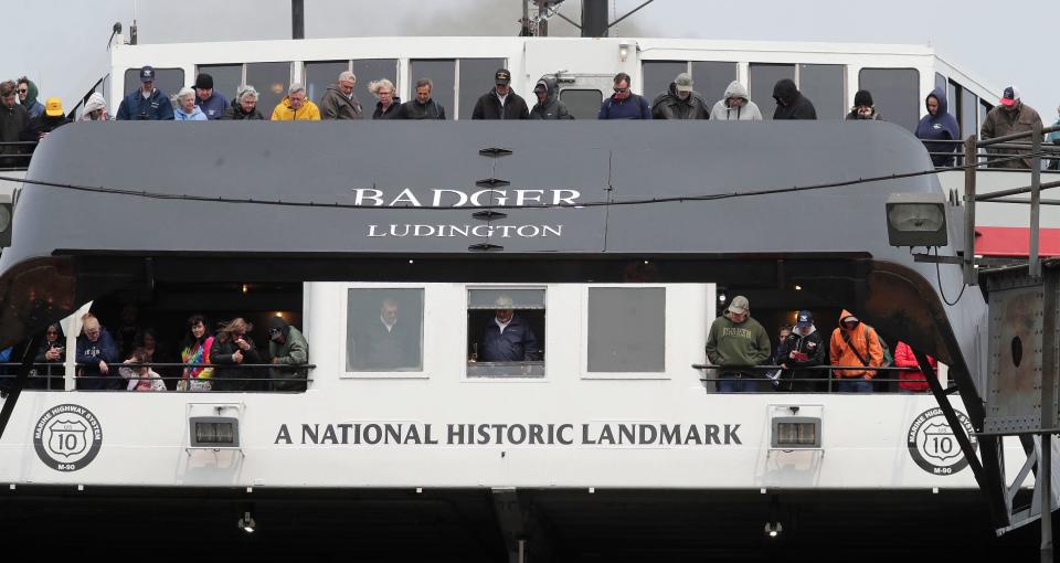 While the captain of the S.S. Badger carefully navigates the ship onto its dock, passengers stand on deck to observe the 70th annual arrival, Thursday, May 18, 2023, in Manitowoc, Wis.