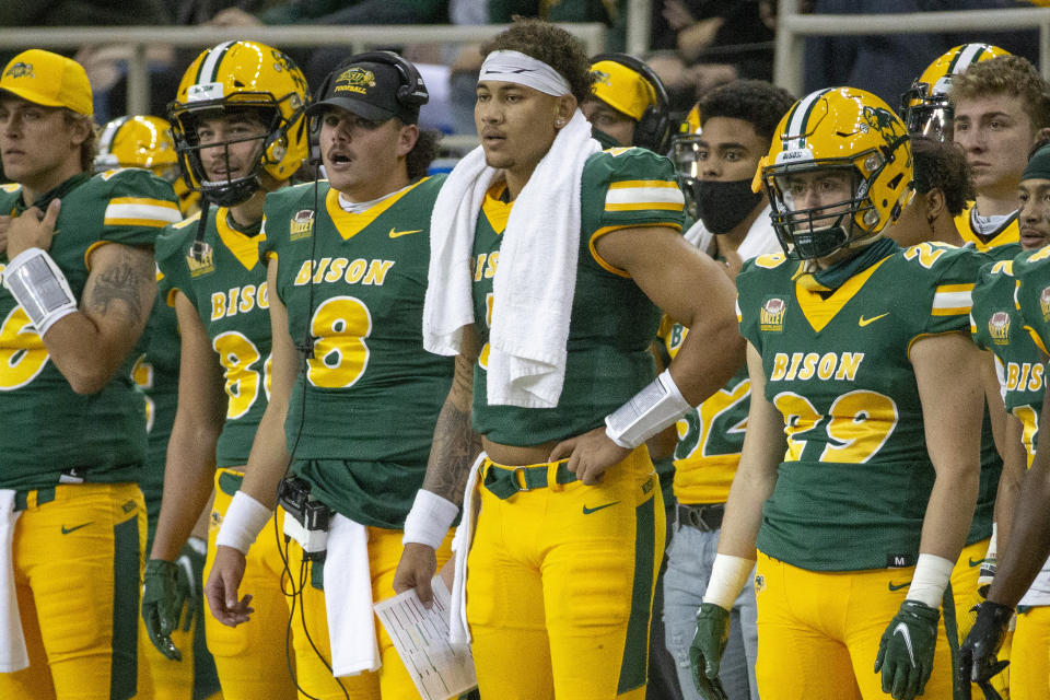 North Dakota State quarterback Zeb Noland (8), quarterback Trey Lance, with towel, and running back Dominic Gonnella (29) watch as their team plays Central Arkansas at an NCAA college football game Saturday, Oct. 3, 2020, in Fargo, N.D. North Dakota State won 39-28. (AP Photo/Bruce Kluckhohn)