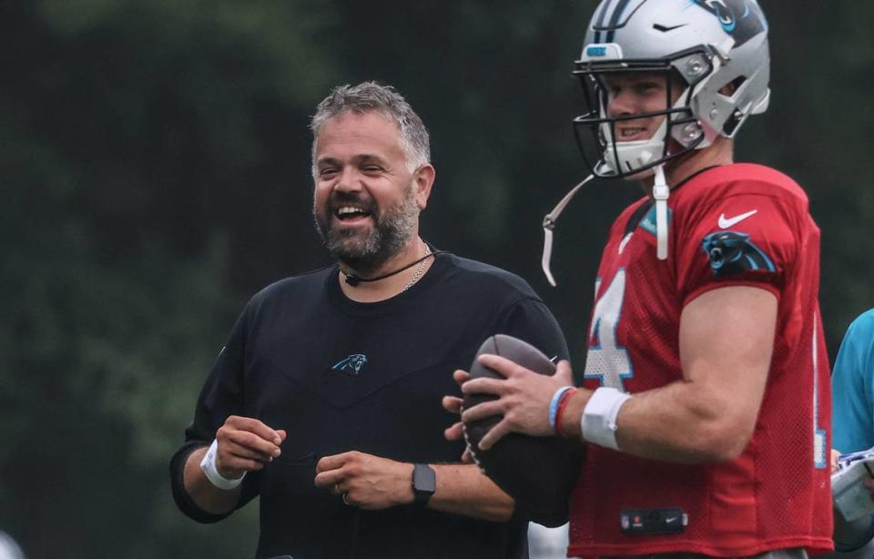 Carolina Panthers coach Matt Rhule, left, shares a laugh with Sam Darnold during a drill during day 6 of the Carolina Panthers training camp at Wofford College in Spartanburg, S.C., on Tuesday, August 3, 2021.