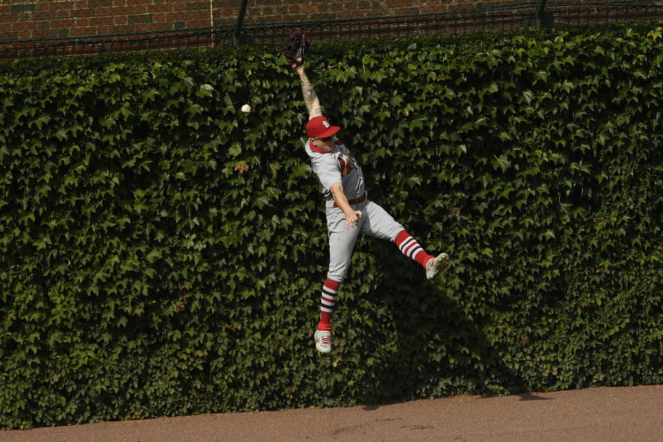 St. Louis Cardinals left fielder Tyler O'Neill misses a double by Chicago Cubs' Ian Happ during the first inning of a baseball game Monday, Sept. 7, 2020, in Chicago. (AP Photo/Paul Beaty)
