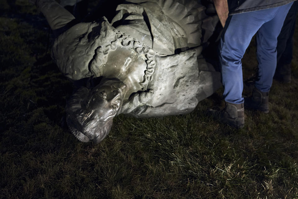 Workers remove the monument to Catherine II, also known as "Monument to the Founders of Odesa" in Odesa, Ukraine, early Thursday, Dec. 29, 2022. The decision to dismantle the monument consisting of sculptures of Russian Empress Catherine II and her associates was made recently by Odesa residents by electronic voting. (AP Photo/LIBKOS)