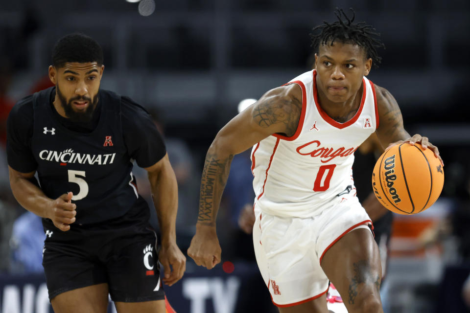 Houston guard Marcus Sasser (0) brings the ball up the court past Cincinnati guard David DeJulius (5) during the first half of an NCAA college basketball game in the semifinals of the American Athletic Conference Tournament, Saturday, March 11, 2023, in Fort Worth, Texas. (AP Photo/Ron Jenkins)