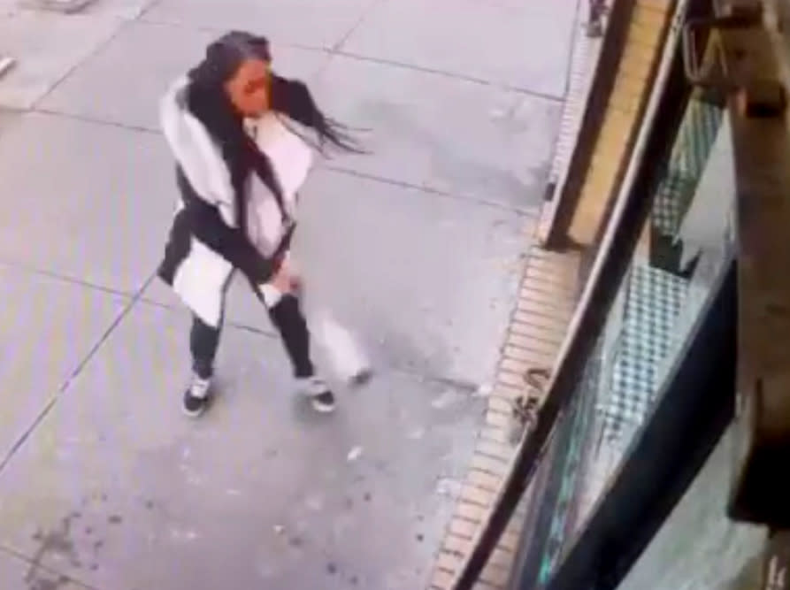 In this Jan. 15, 2019 image taken from surveillance video, a woman smashes the windows of "Back Home Restaurant" in the Bronx borough of New York. Police say that she became upset after ordering a patty and was told that the restaurant had run out of them. She returned with a bat and smashed two windows. (New York City Police Department via AP)