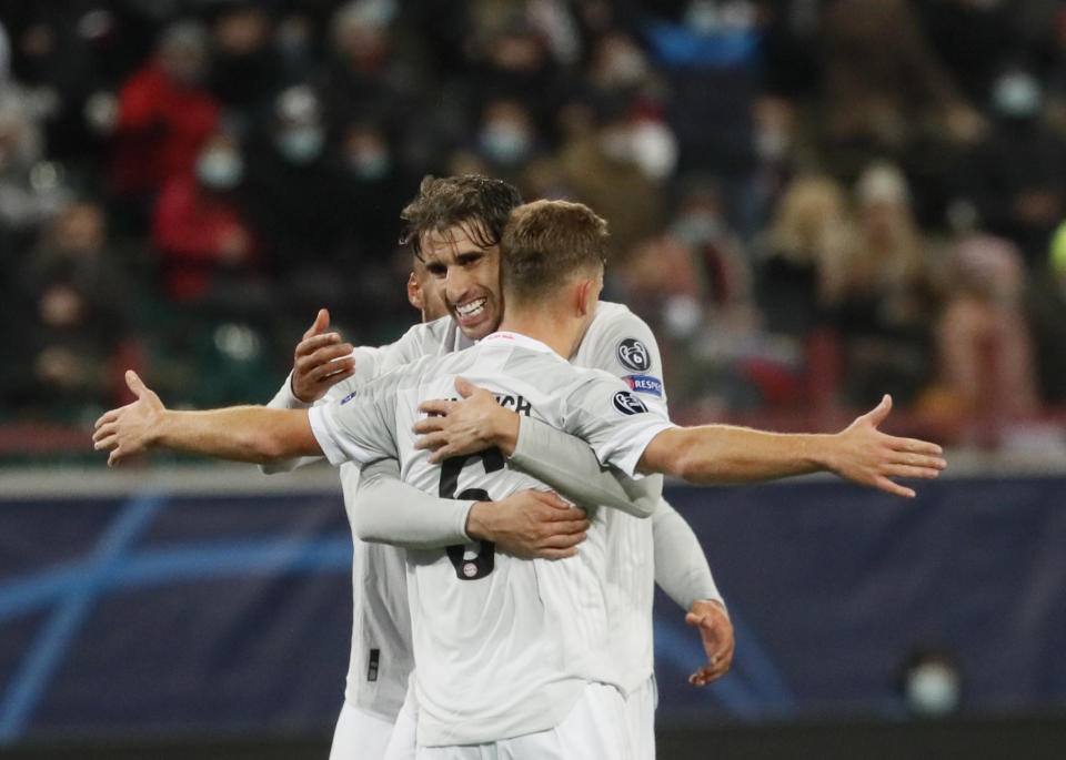 Bayern's Joshua Kimmich celebrates with teammate Bayern's Javi Martinez after scoring his side's second goal during the Champions League group A soccer match between Lokomotiv Moscow and Bayern Munich in Moscow, Russia, Tuesday, Oct. 27, 2020. (Maxim Shipenkov/Pool via AP)