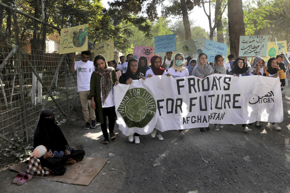 Young people attend a Climate Strike rally, in Kabul, Afghanistan, Friday, Sept. 20, 2019. In the Afghan capital, where people are dying every day in horrific bomb attacks, a young generation, worried that if war doesn't kill them climate change will, took part in the global climate strike. (AP Photo/Ebrahim Noroozi)