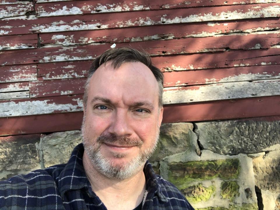 Average Joe columnist Joe Thomas poses for a selfie by the Old Red Barn in October 2019 at Dussel Farm in Brimfield.