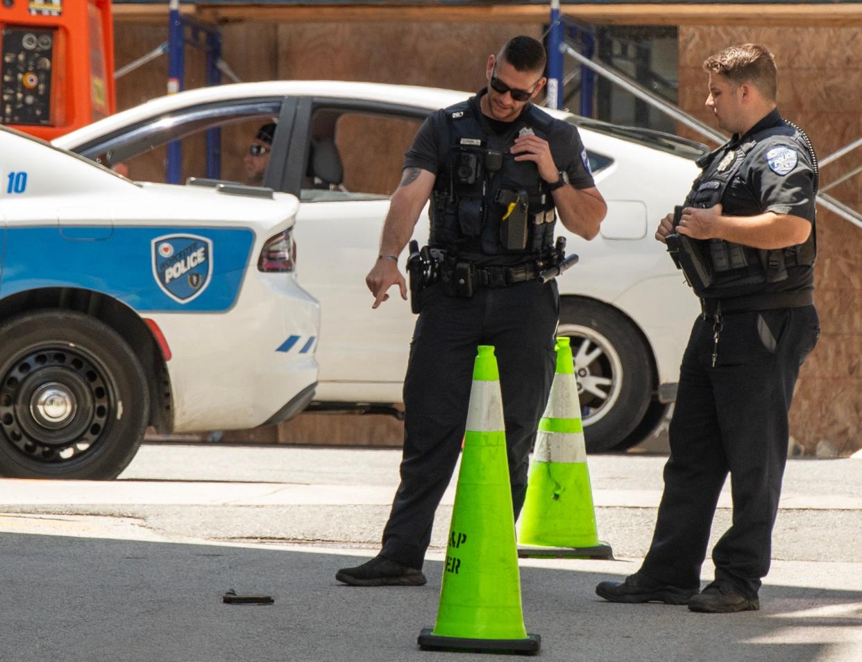 Worcester police officers guard a knife and phone on the ground on Green Street where a person was taken into custody Wednesday afternoon.