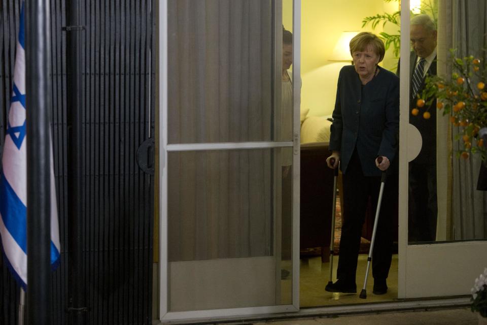 Germany's Chancellor Angela Merkel walks with Israeli Prime Minister Benjamin Netanyahu during their meeting at the Prime minister's residence in Jerusalem, Monday, Feb. 24, 2014. (AP Photo/Sebastian Scheiner)