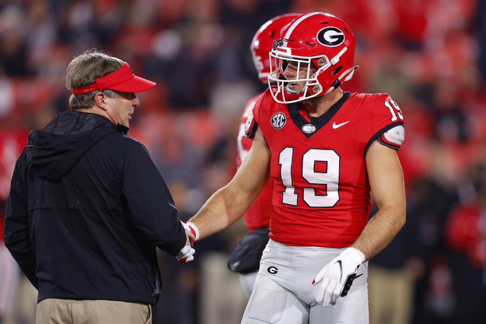 ATHENS, GEORGIA – NOVEMBER 11: Head coach Kirby Smart of the Georgia Bulldogs speaks with Brock Bowers #19 prior to the game against the Mississippi Rebels at Sanford Stadium on November 11, 2023 in Athens, Georgia. (Photo by Todd Kirkland/Getty Images)