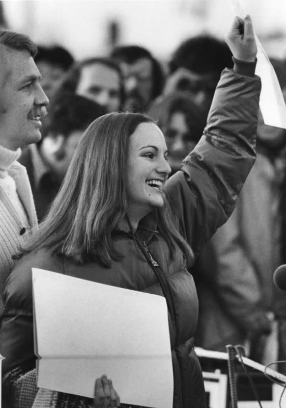 Patricia Hearst waves the executive grant of clemency as she leaves prison in Pleasanton, Calif., on February 1, 1979, after serving 22 months of a seven-year sentence for taking part in an SLA bank robbery. On February 4, 1974, urban guerrillas calling themselves the Symbionese Liberation Army abducted Hearst from her apartment in Berkeley, Calif. UPI File Photo
