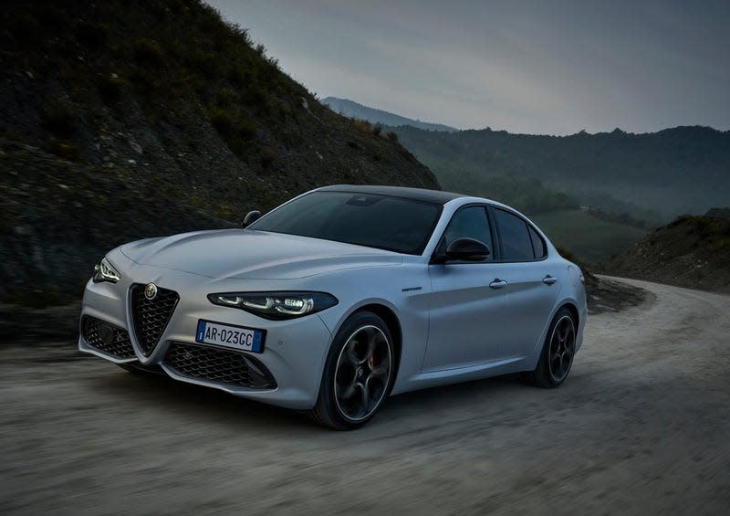 An Alfa Romeo Giulia 2.0 T driving on a dirt road