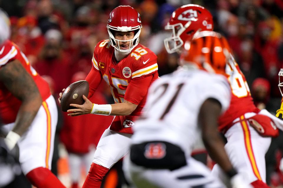 Kansas City Chiefs quarterback Patrick Mahomes (15) takes the snap during the AFC championship game against the Cincinnati Bengals at Arrowhead Stadium.