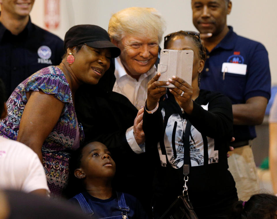 <p>President Donald Trump poses for a photo with a family at a Hurricane Relief Center where he met with flood survivors of Hurricane Harvey, in Houston, Texas, Sept. 2, 2017. (Photo: Kevin Lamarque/Reuters) </p>