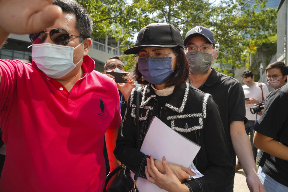 Mrs. Poon, the mother of a young woman killed in Taiwan, speaks to the media outside the government headquarters in Hong Kong, Wednesday, Oct. 20, 2021. Mrs. Poon, whose daughter Poon Hiu-wing was killed while visiting Taiwan in 2018, has lambasted Hong Kong authorities for letting suspect Chan Tong-kai walk free, instead of sending him to Taiwan to turn himself in. (AP Photo/Kin Cheung)