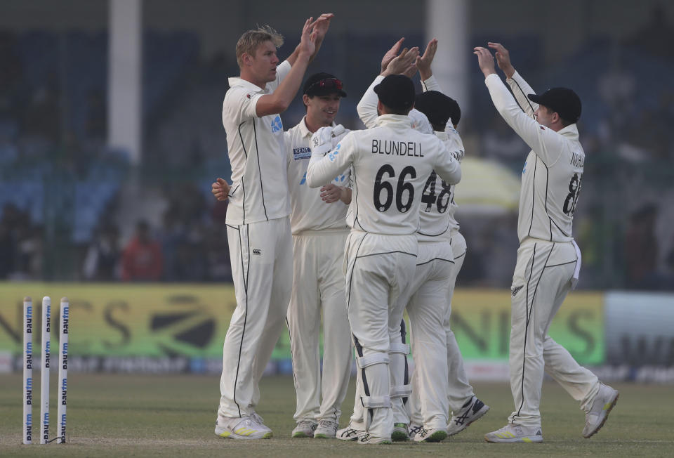 New Zealand's Kyle Jamieson, left, celebrates the wicket of India's Shubman Gill with his teammates during the day three of their first test cricket match in Kanpur, India, Saturday, Nov. 27, 2021. (AP Photo/Altaf Qadri)