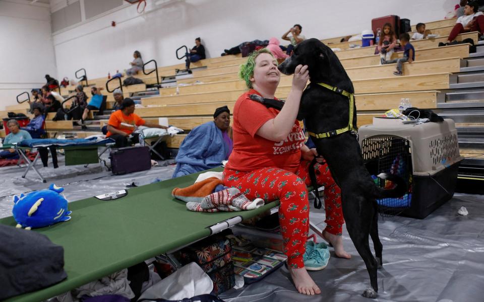 Amber Hardin, 27,  with her dog Ducky while taking shelter from Hurricane Helene at Leon High School near downtown Tallahassee