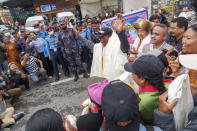 Veteran Sherpa guide Kami Rita, center, arrives at the airport in Kathmandu, Nepal, Thursday, May 25, 2023. The 53-year-old guide scaled Mount Everest for the 28th time on Tuesday beating his own record within a week as two guides compete with each other for the title of most climbs of the world's highest peak. (AP Photo/Niranjan Shrestha)