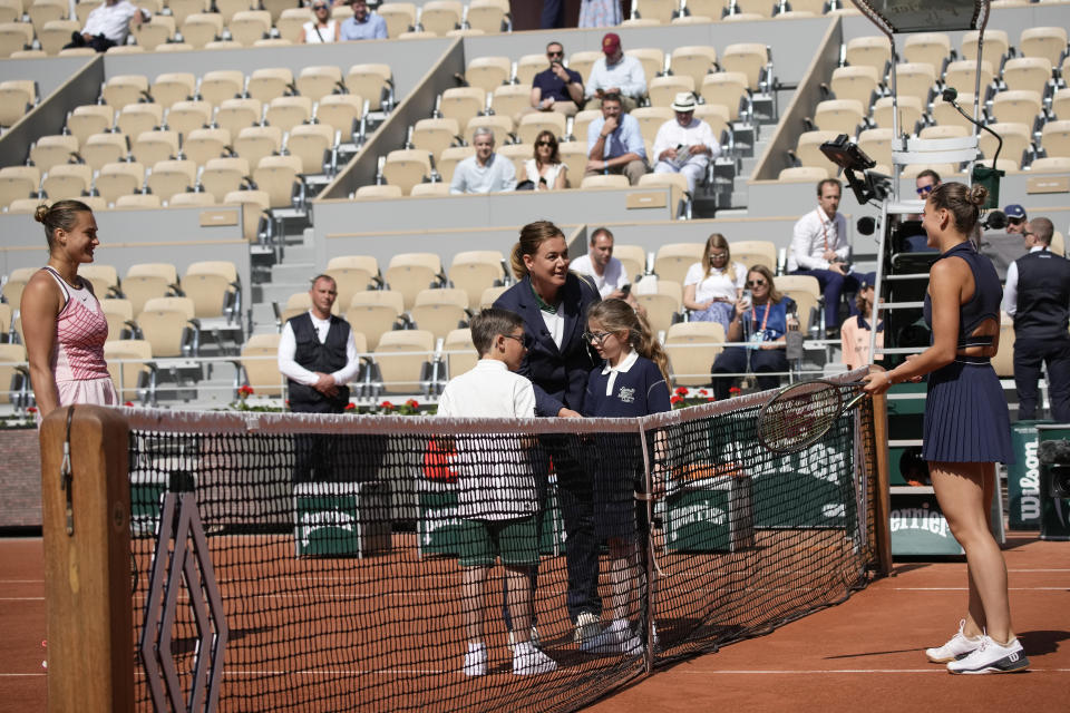 Aryna Sabalenka of Belarus, left, and Ukraine's Marta Kostyuk, right, did not greet each other and refused to pose for the traditional pre-match picture with the ball children in their first round match of the French Open tennis tournament at the Roland Garros stadium in Paris, Sunday, May 28, 2023. (AP Photo/Christophe Ena)