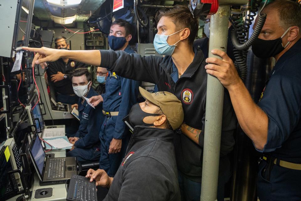 Sailors aboard the submarine USS Chicago coordinate the launch of a Harpoon anti-ship missile during SINKEX