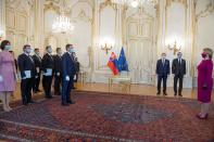 Newly appointed Slovak Prime Minister Igor Matovic (C), leader of the OLaNO anti-graft party, members of his cabinet and President Zuzana Caputova (R) take part in a swearing in ceremony of the new four-party coalition government on March 21, 2020 at the Presidential palace in Bratislava. - The ceremony was held without members of the press and all appointed government members wore gloves and face mask to prevent the spread of novel coronavirus. (Photo by Michal Svítok / POOL / AFP) (Photo by MICHAL SVITOK/POOL/AFP via Getty Images)