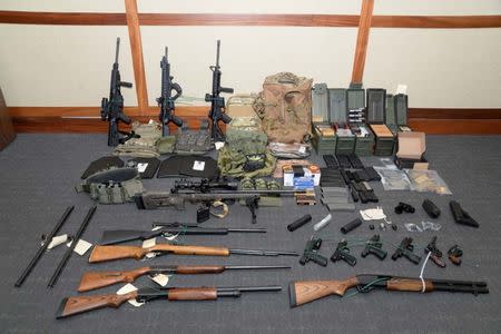 A cache of guns and ammunition uncovered by U.S. federal investigators in the home of U.S. Coast Guard lieutenant Christopher Paul Hasson in Silver Spring, Maryland, U.S., is shown in the photo provided February 20, 2019. U.S. Attorney's Office Maryland/Handout via REUTERS