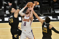 Phoenix Suns forward Frank Kaminsky (8) shoots against Memphis Grizzlies guards Dillon Brooks (24) and Tyus Jones (21) in the second half of an NBA basketball game Monday, Jan. 18, 2021, in Memphis, Tenn. (AP Photo/Brandon Dill)