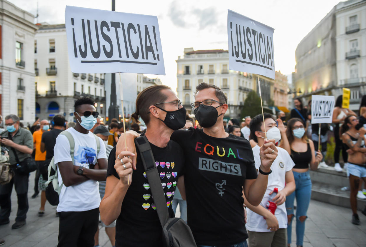 A gay couple hold placards during the demonstration. Movimiento Marica Madrid goes ahead with the concentration at Puerta del Sol, to denounce the homophobic aggressions and against the LGTBi collective, even after it became known that the aggression suffered on last Sunday in Malasa�a, by a young man was consensual. A 20-year-old gay man reported to the police, that on last Sunday, he was assaulted by a group of hooded men, in the entrance to his apartment block, in the Malasa�a neighborhood. Today he has retracted and told the police that the wounds were not the result of an assault. (Photo by Gustavo Valiente / SOPA Images/Sipa USA)