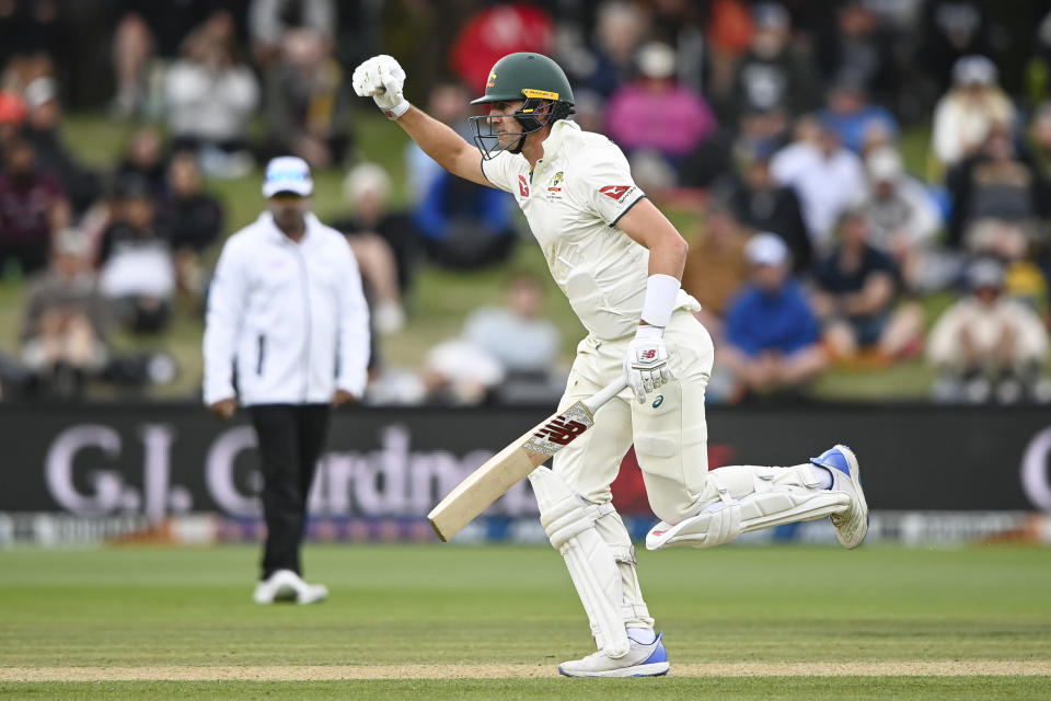 Australia's Pat Cummins celebrates after hitting the winning runs to defeat New Zealand by three wickets on day four of the second cricket test between New Zealand and Australia in Christchurch, New Zealand, Monday, March 11, 2024. (John Davidson/Photosport via AP)