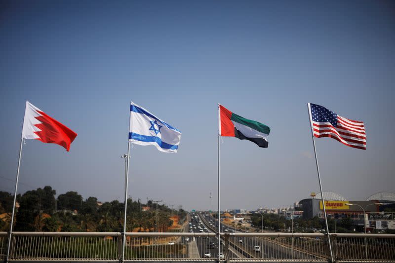 The flags of the U.S., United Arab Emirates, Israel and Bahrain flutter along a road in Netanya
