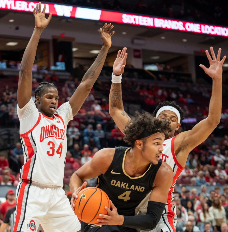 Nov 6, 2023; Columbus, OH, USA;
Ohio State Buckeyes’ center Felix Okpara (34) and guard Roddy Gayle Jr. (1) block Oakland Golden Grizzlies forward Trey Townsend (4) from shooting during the first half of their game on Monday, Nov. 6, 2023 at the Value City Arena.