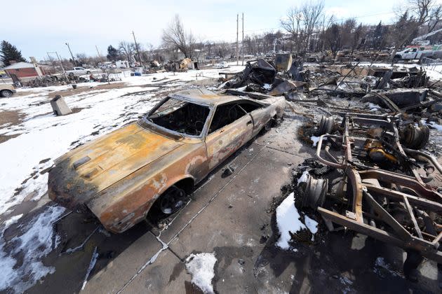 Charred vehicles sit amid the rubble of a home destroyed by wildfires Wednesday in Superior, Colorado.  (Photo: David Zalubowski/AP)