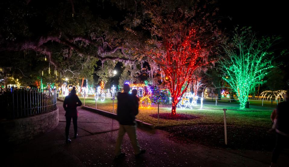 The lights at Oaks By The Bay Park in St. Andrews are a colorful attraction drawing crowds of people. 