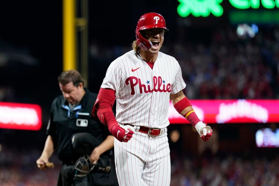 Philadelphia Phillies' Bryson Stott reacts after hitting a grand slam against Miami Marlins pitcher Andrew Nardi during the sixth inning of Game 2 in an NL wild-card baseball playoff series, Wednesday, Oct. 4, 2023, in Philadelphia. (AP Photo/Matt Slocum)