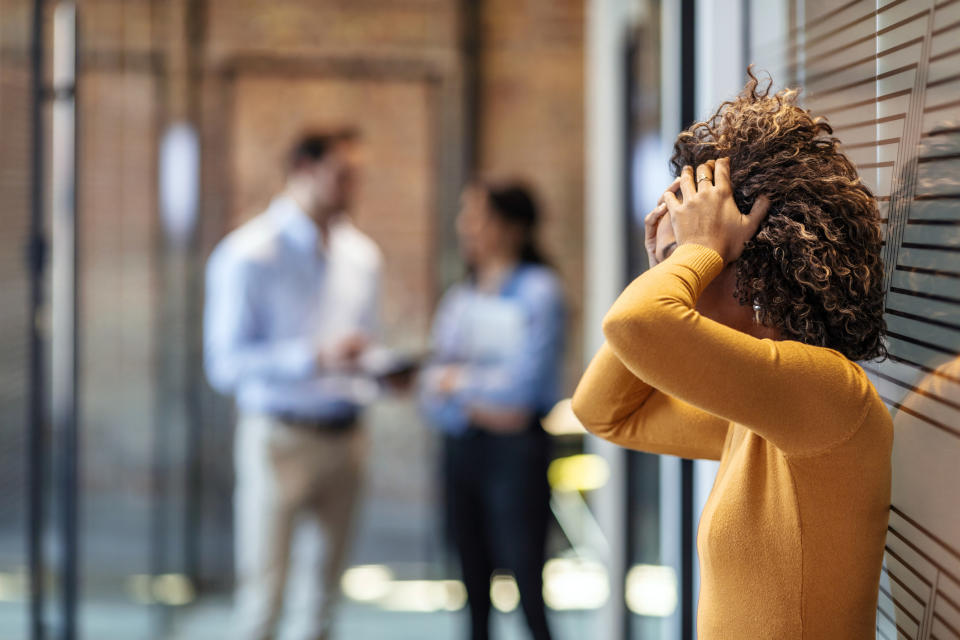 A frustrated woman with her hands on her head