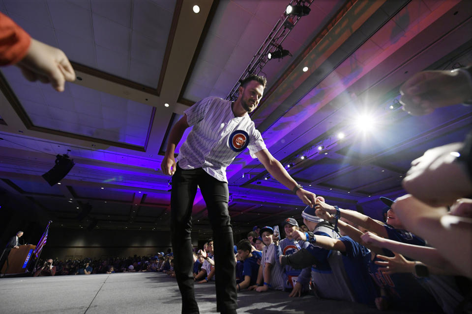Chicago Cubs' Kris Bryant fist-bumps fans after being announced during the baseball team's convention Friday, Jan. 17, 2020, in Chicago. (AP Photo/Paul Beaty)