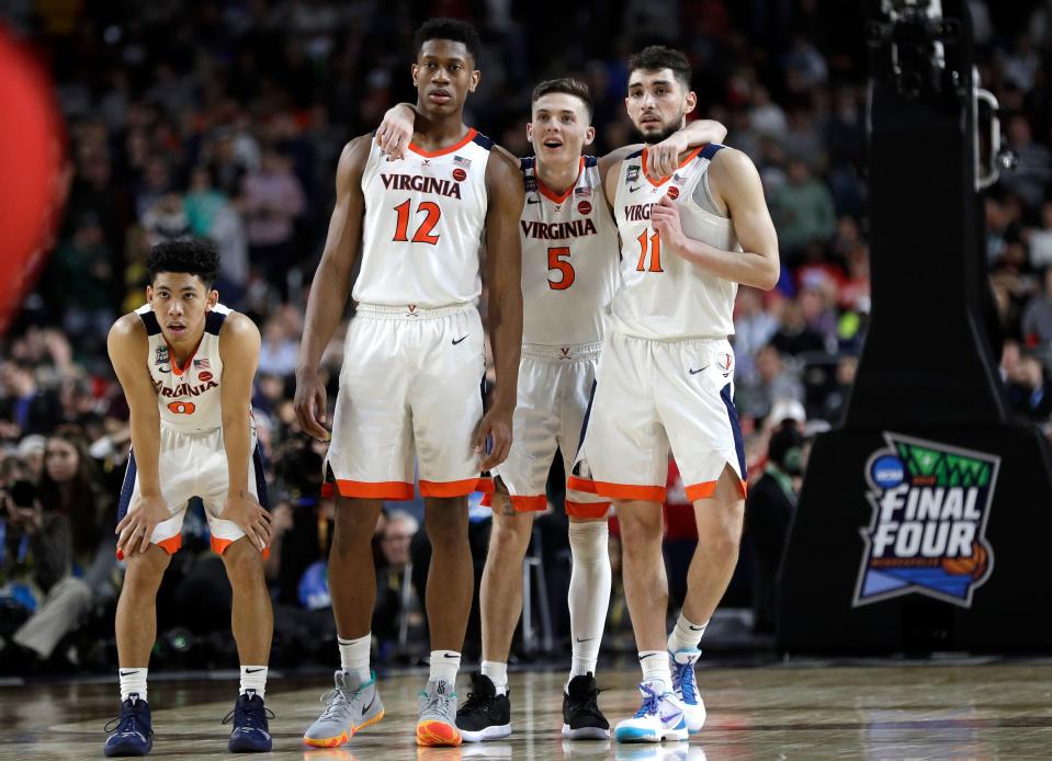 Virginia players Kihei Clark, from left, De'Andre Hunter, Kyle Guy and Ty Jerome celebrate at the end of the championship game against Texas Tech in the Final Four NCAA college basketball tournament, Monday, April 8, 2019, in Minneapolis. Virginia won 85-77 in overtime. (AP Photo/David J. Phillip)