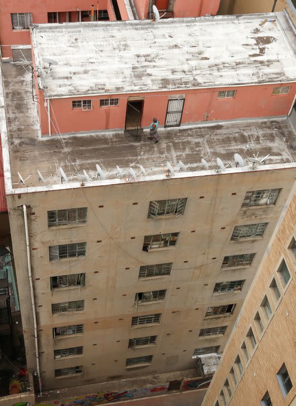 A woman walks on a rooftop, during a nationwide lockdown for 21 days to try to contain the coronavirus disease (COVID-19) outbreak, in Braamfontein