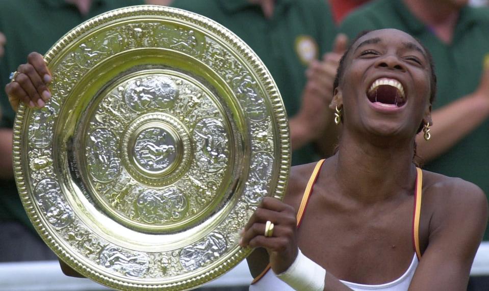 FILE - In this July 8, 2000, file photo, U.S. tennis player Venus Williams laughs as she holds the women's singles trophy on Centre Court at Wimbledon. (AP Photo/Adam Butler, File)