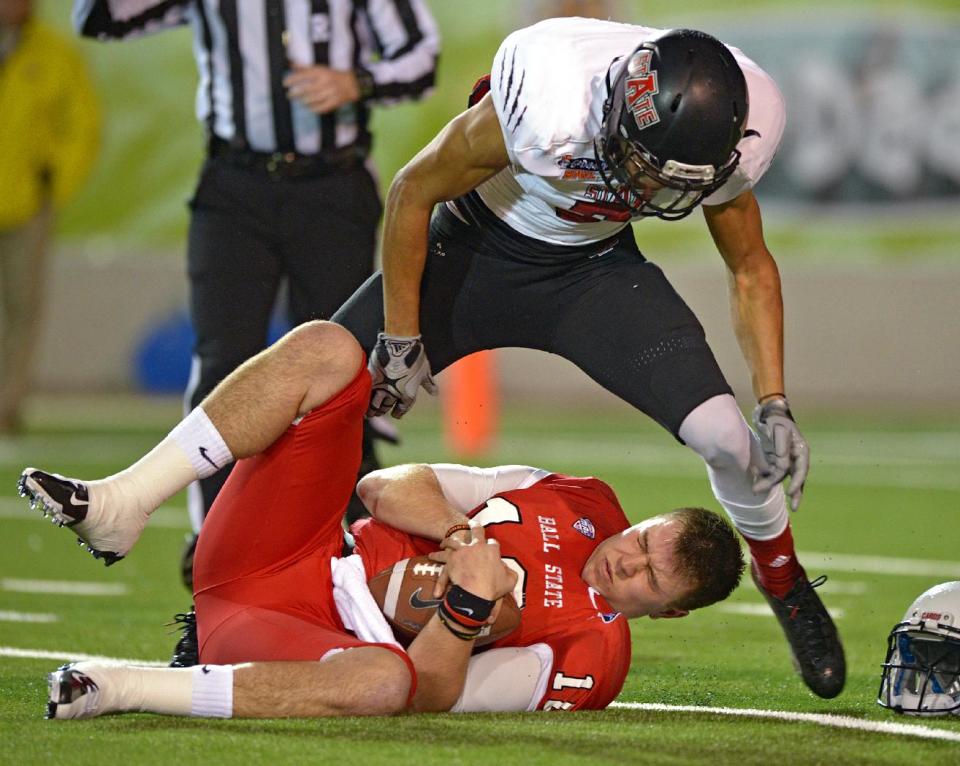 Arkansas State defensive back Rocky Hayes (3) stands over Ball State quarterback Keith Wenning (10) following a sack in the first quarter of the GoDaddy Bowl NCAA college football game, Sunday, Jan. 5, 2014, in Mobile, Ala. (AP Photo/G.M. Andrews)