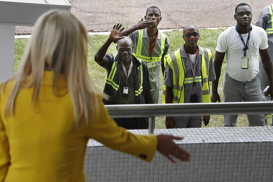 U.S. White House senior adviser Ivanka Trump, left, waves back at airport workers as one blows a kiss and others wave as she arrives at the airport in Abidjan, Ivory Coast, Tuesday April 16, 2019, after flying in from Ethiopia. Trump is visiting Ivory Coast to promote a White House global economic program for women, after a previous stop in Ethiopia. (AP Photo/Jacquelyn Martin)