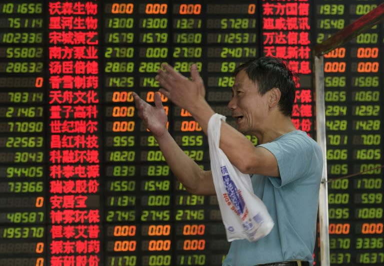 An investor reacts in front of screens showing stock market movement at a brokerage house in Shanghai on September 1, 2015